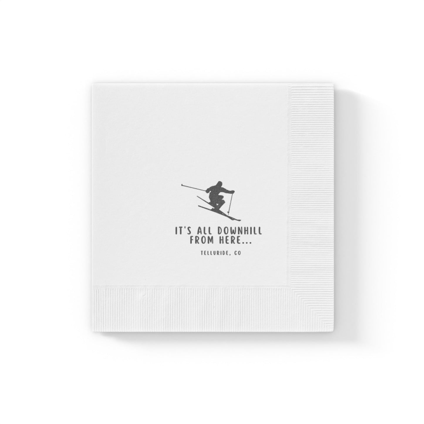 White printed birthday napkins with a skier, black lettering saying "It's All Downhill From Here" and Telluride, CO. The napkins are made of soft, absorbent paper and are perfect for use at parties or other events. The skier in the image is a reference to Telluride Ski Resort, a popular ski resort in Colorado. These napkins are a great way to celebrate a birthday or other special occasion with a touch of humor and a nod to the apres ski lifestyle.